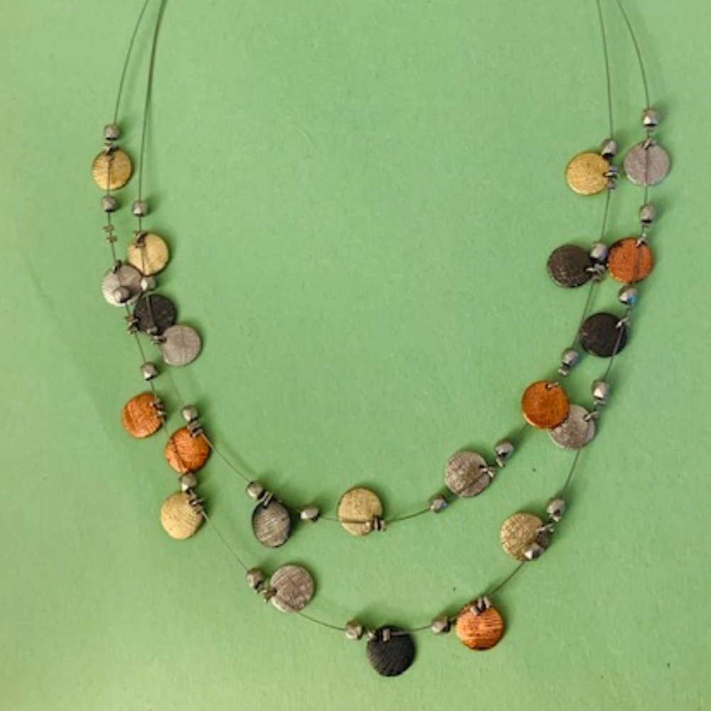 Multi-strand wire necklace with multiple metal accents. NEW